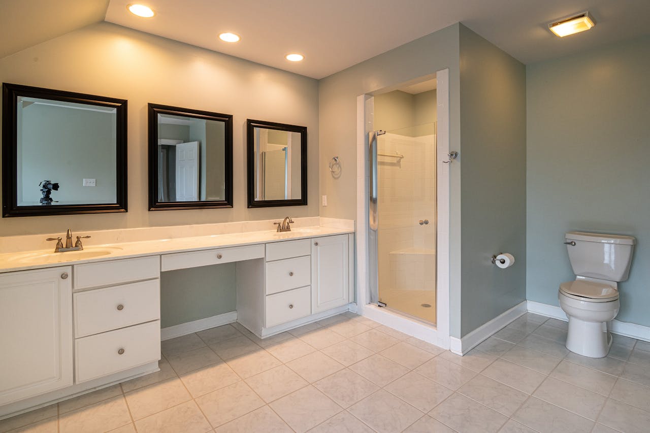 Spacious contemporary bathroom with dual sinks and a shower panel.